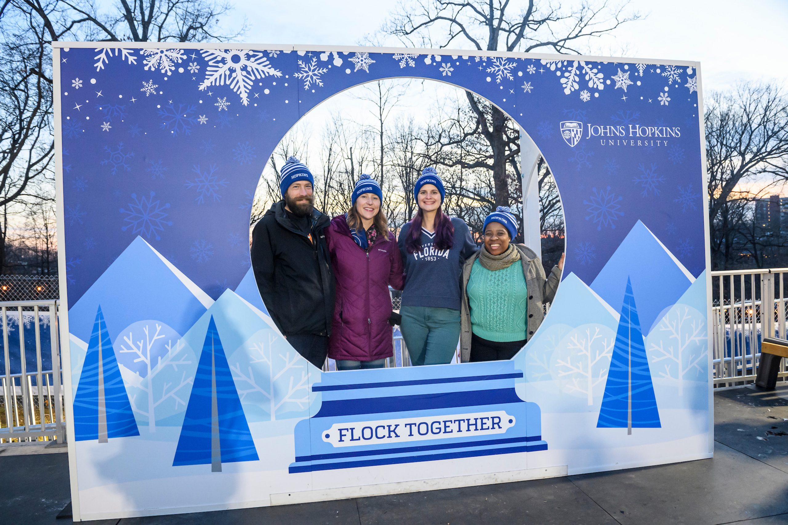 Group posing in a snow globe cutout design