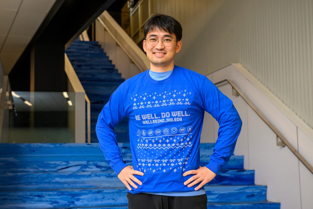 Student wearing shirt that says "Be Well. Do Well."